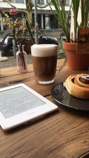 latte with oat milk and a cinnamon roll at Veg room in Berlin