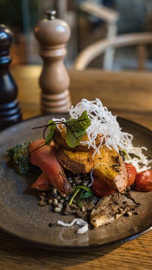 Oven-baked sweet potato with mung beans, kale pesto, mushrooms, pear at Rataskaevu 16 in Tallinn