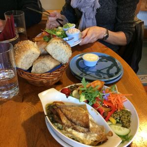 Snack sized Deli dish (top).
Bread rolls for two Deli dishes, served with vegan butter.
Snack sized vegan Spinach and Mushroom Pancakes. at The Green Way Cafe in Matlock
