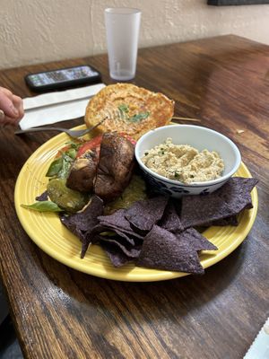 The portobello burger was the special today. You can get it with a gf bun. This came with a side of hummus and chips    at Wildflower Cafe and Bakery in Arcata