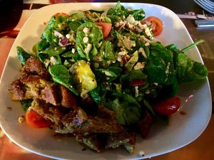 Vegan St. Stephen’s salad with added falafel. It’s a spinach salad, with roasted cauliflower, quinoa, couscous, tomatoes, banana peppers, red onion, with avocado dressing. at Guyutes in Oklahoma City