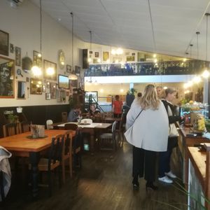 Interior walking in: seats stairs, and more seats to the left.  Order to your right. at Munch in Palmerston North