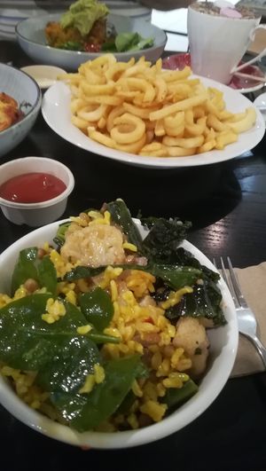 Salad bowl, curly fries, corn cakes with heaps of guacamole, and mochaccino.  at Munch in Palmerston North