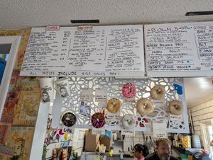 Donut display inside of Old Abe's Coffee with the day's flavors at Drift Dough in Rochester