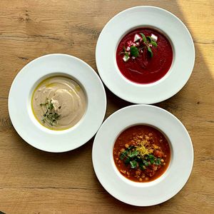 Krem z pieczonego buraka na mleku kokosowym z weganska feta i mieta,  krem z pieczonego kalafiora z tahina,  zupa z ciecierzycy z kminem rzymskim i pomidorami at Szybka Pizza in Poznan