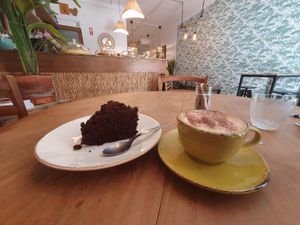 Coffee with oat Milk and cake at Cabane  in Lisbon