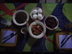Tofu with greens, harricots with vegetable, fried plantains and steamed dumplings. Very interesting flavors! Delicious. at Djinkoume House in Dakar