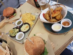 Burger with tapas and fries on the side at Veggie Burger by Biocenter in Barcelona