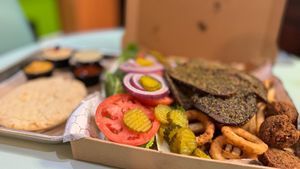 MUNCHY BOX
2 sides of seitan kebab, 1 side of meatballs, 2 sides of french fries, 8 onion rings, 1 side of falafel, hummus, mixed salad, BBQ sauce, cheese sauce, tzatziki and 2 pi at Vegan Community Kitchen in Apex