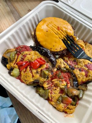 The Eggplant Parmesan plate with tomato and béchamel sauce. A veggie patty and cheese. If you like creamy eggplant, you’ll love this! at Vegan Community Kitchen in Apex