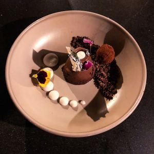 Chocolate and coconut textures. Vegan, with eatable silver flower. at Arthouse Restaurant-Bar in Tulum