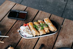 Vege Spring Roll with shiitake mushrooms tofu, green vegetables and glass noodles. Deep-Fried. Served with optional sauce and slaw. Four pieces.  at Sushi Soldier Eightgrains  in Christchurch
