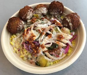 Basmati rice bowl with falafel, chopped salad, purple cabbage, sumac onions, Naf pickles, tahini & lemon vinaigrette (vegan). Free pita not showing. at Naf Naf Grill in Eagan
