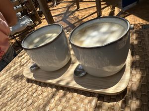 Oat latte & americano on a bamboo tray baby   at Balance Cafe in Portimao