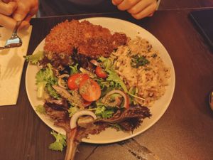 Fish with tomato rice and salad at Kong - Food Made With Compassion in Lisbon