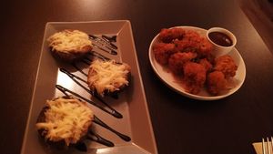 Mushrooms with bacon and cheese and cauliflower wings at Kong - Food Made With Compassion in Lisbon