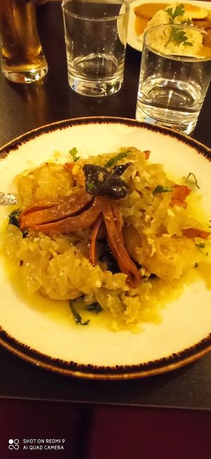 "Octopus" with potatoes, caramelized onions and spinach at Kong - Food Made With Compassion in Lisbon