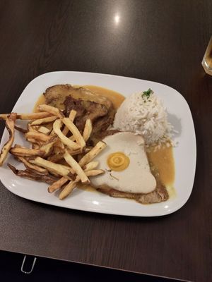 Seitan steak with rice and potatoe fries and a sunny side up, served with a special mustard sauce at Kong - Food Made With Compassion in Lisbon