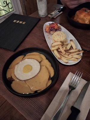 Seitan Steak with Mustard Sauce and vegan fried Egg with Rice , Fries and Salad at Kong - Food Made With Compassion in Lisbon