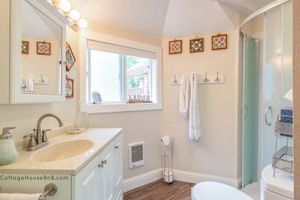 Private 3/4 bathroom. Heated floors & wall heater in winter. Cold bidet toilet seat. Rain and hand held shower heads.   at Cottage House Vegan Airbnb in West Linn
