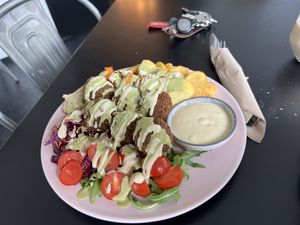 Falafel Plate (Falafel, Hummus, Carrot fries, Baked potatoes, red cabbage, rocket, tomatoes)  at Tavci Kuhna in Lesce
