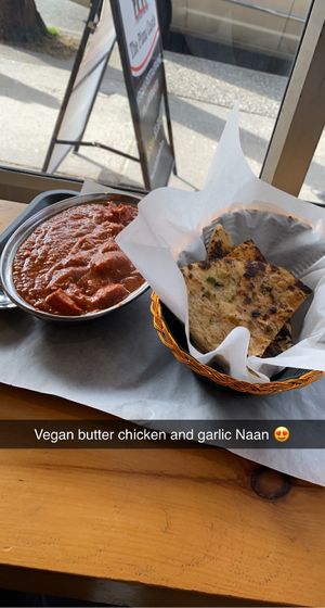 Vegan butter chicken and warm toasted garlic naan. SO GOOD! at The Pizza Castle and Indian Curry in Vancouver