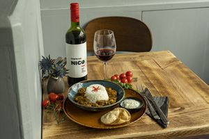 Mushroom curry with a mound of rice, coriander yog and crunchy poppadoms at Supplant Foods  in North London