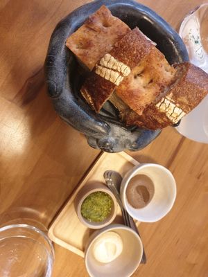 Sourdough bread, focaccia, cashew cream, cashew cream with black garlic and pesto at Arkhe in Lisbon