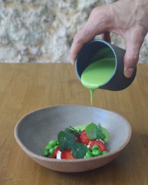 Chilled pea & kombucha soup, cashew cream, pickled strawberry, walnuts soil, dill at Arkhe in Lisbon