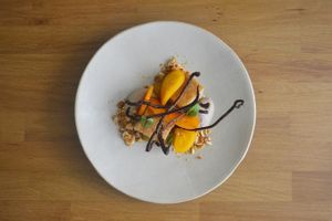 Almond rum cake, chestnut cream, persimmon, orange gel, chocolate 70% at Arkhe in Lisbon