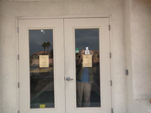 Putting up HappyCow sticker at Govinda's Cafe in Las Vegas