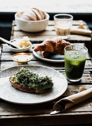 Breakfast - avocado on toast, green juice and croissants.  at ubat veggie in Aalborg