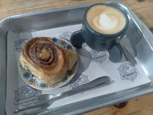 Cinnamon roll with cappuccino for 58 reais. ;) at Astronauta in Sao Paulo
