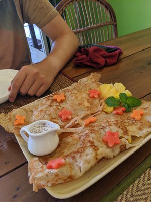 Crispy coconut pancake with banana, pineapple and coconut sauce at Papa's  in Kampot