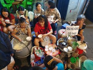 Front View. Daughter speaks English at Hot Tofu - Food Stand in Ho Chi Minh City