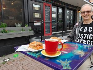 Exterior of Lotus Bleu. Note the dog water bowls, handicap accessible entrance, and the window planters with vegetables and herbs. at Lotus Bleu Cafe in Edmundston