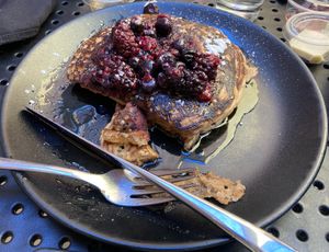 Vegan pancakes with berries, powdered sugar, and syrup. at The Hummingbird Cafe in Butte