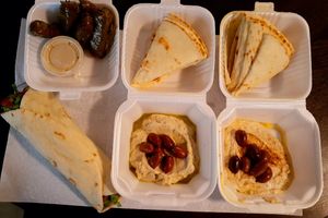 Dolmades (grape leaves), baba ganoush, hummus, and falafel sandwich. Fit for royalty. at Sophi's Mediterranean Cafe & Market in Biloxi