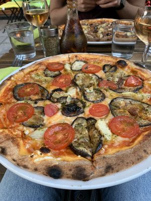 Pizza with vegan mozzarella, tomatoes, eggplant, artichokes and basil  at Happiz - Monge in Paris