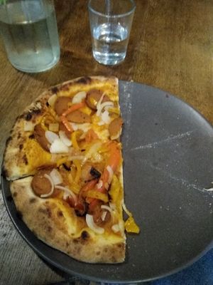 Half of my ordered pizza at Happiz - Monge in Paris