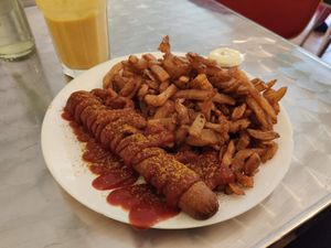 Currywurst and massive serving of chips 😊 at Yoyo Foodworld in Berlin