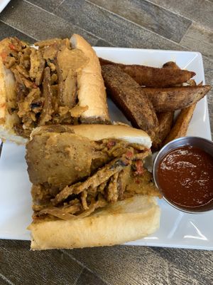 Philly cheesesteaks with a side of seasoned fries. Fries are a little salty. Doesn’t take like a regular Philly cheesesteak sandwich but it is delicious! 9/10!   at The Stand Vegan Cafe in Fairfield