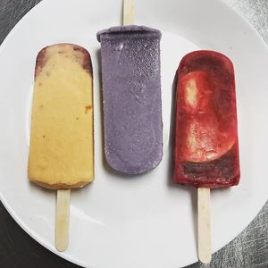 Ignore the yellow & purple popsicles because those are made with cream but please order the Mexican Ponche - "Hibiscus punch with hints of guava, cinnamon, & orange." It is vegan! at Yelo in Geneva