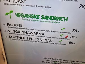 Indoor tv screen mentiins 3 vegan options at Cafe K in Fredericia