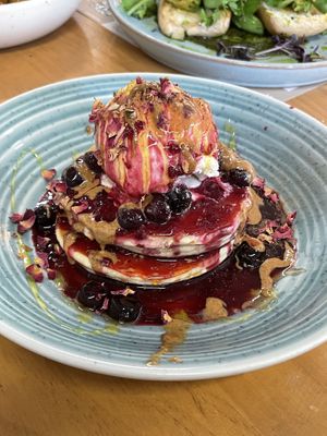 Pancakes with berries with extra almond butter on top  at WAVE in East London