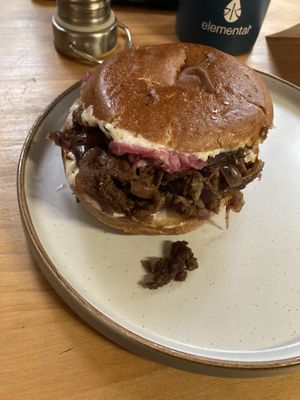 Brisket brioche with caramelize onions, sauerkraut, gherkins, and horseradish mayo  at WAVE in East London