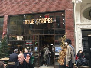 Front entrance, plus outdoor seating. at Blue Stripes Cacao Shop in New York City
