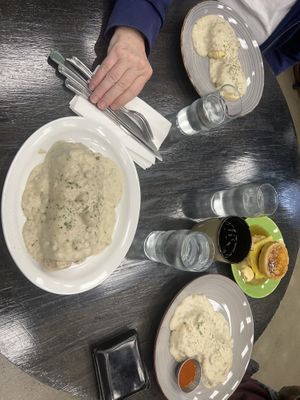 Smothered breakfast burrito, biscuits and gravy and sausage egg n cheese pan’wich. at Sage Against The Machine in Bellingham