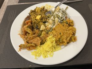 Dinner plate.  Cabbage dish , saag with tofu paneer some kind of slaw, I honestly don’t know what everything is  at Jardim das Cerejas - Chiado in Lisbon
