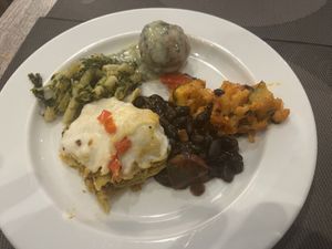 Meatball with gravy, some lasagna looking thing that tasted like cornbread between noodles, noodles with greens, something else, black beans  at Jardim das Cerejas - Chiado in Lisbon